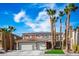 Charming home featuring a tile roof, desert landscaping, palm trees, and a spacious two-car garage at 506 Staghorn Pass Ave, Las Vegas, NV 89183