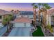 Beautiful two-story home features a tile roof, solar panels, a two-car garage, and desert landscaping at 506 Staghorn Pass Ave, Las Vegas, NV 89183