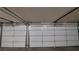 Open garage door view featuring an electric opener, hardware, and white sectional panels at 506 Staghorn Pass Ave, Las Vegas, NV 89183