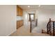 Upstairs hallway with built-in cabinets, decorative railing, and carpeted floors creating a transition to other rooms at 506 Staghorn Pass Ave, Las Vegas, NV 89183