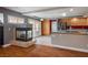 Open kitchen and dining area featuring wood cabinets, a fireplace, and tile flooring at 506 Staghorn Pass Ave, Las Vegas, NV 89183