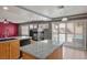 Modern kitchen features granite countertops, an island, stainless steel appliances, and a pool view at 506 Staghorn Pass Ave, Las Vegas, NV 89183