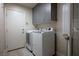A functional laundry room with side-by-side washer and dryer, and ample cabinet storage at 506 Staghorn Pass Ave, Las Vegas, NV 89183