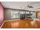 Spacious living room with hardwood floors, a fireplace, a ceiling fan, and natural light at 506 Staghorn Pass Ave, Las Vegas, NV 89183