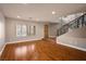 Spacious living room with hardwood floors, large windows with plantation shutters, and neutral paint at 506 Staghorn Pass Ave, Las Vegas, NV 89183