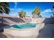 Backyard features a uniquely shaped pool with a stone waterfall feature and plenty of patio space at 506 Staghorn Pass Ave, Las Vegas, NV 89183