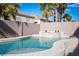 Backyard pool with waterfall feature surrounded by block wall for privacy at 506 Staghorn Pass Ave, Las Vegas, NV 89183