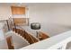 A modern staircase featuring hardwood steps, a wrought iron railing, and a decorative chandelier at 506 Staghorn Pass Ave, Las Vegas, NV 89183