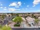 Scenic aerial view of a neighborhood with well-maintained homes and lush landscaping under a blue sky at 5107 Morning Splash Ave, Las Vegas, NV 89131