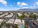 Community aerial view showcasing lush landscaping, street layout, and a view of the surrounding mountains at 5107 Morning Splash Ave, Las Vegas, NV 89131