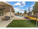 Beautiful backyard featuring a covered patio, pool, green space, and trampoline at 5107 Morning Splash Ave, Las Vegas, NV 89131