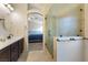 A spacious bathroom featuring dual sinks, a glass shower, and views of the bedroom at 5107 Morning Splash Ave, Las Vegas, NV 89131