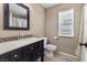 A bathroom with a wood vanity, tiled floors, and neutral colored walls at 5107 Morning Splash Ave, Las Vegas, NV 89131
