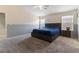 This bedroom features a ceiling fan, carpet floors, and neutral-colored walls at 5107 Morning Splash Ave, Las Vegas, NV 89131
