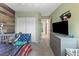 A well-lit bedroom with a closet, dresser, and a wood paneled accent wall at 5107 Morning Splash Ave, Las Vegas, NV 89131