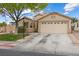 Front exterior of a single-story home with a two-car garage and a manicured lawn in a suburban setting at 5107 Morning Splash Ave, Las Vegas, NV 89131