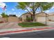 Charming single-story home with a two-car garage and a well-kept front yard featuring a mature tree and RV parking at 5107 Morning Splash Ave, Las Vegas, NV 89131