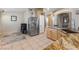 Bright kitchen featuring tile floors, granite countertops, and stainless steel refrigerator at 5107 Morning Splash Ave, Las Vegas, NV 89131