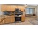 Well-lit kitchen featuring wood cabinets, granite countertops, stainless appliances, and a cozy breakfast nook at 5107 Morning Splash Ave, Las Vegas, NV 89131