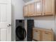 This laundry room features modern appliances and wooden cabinets at 5107 Morning Splash Ave, Las Vegas, NV 89131