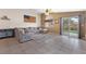 Open living room area with a sectional couch and sliding glass door to backyard at 5107 Morning Splash Ave, Las Vegas, NV 89131