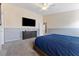 Main bedroom features a large bed, a TV, and an ensuite bathroom at 5107 Morning Splash Ave, Las Vegas, NV 89131