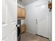 A well-lit mudroom with overhead cabinets and tile floors at 5107 Morning Splash Ave, Las Vegas, NV 89131