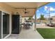 Covered patio with dining table, outdoor fridge, and view of the pool and landscaped backyard at 5107 Morning Splash Ave, Las Vegas, NV 89131