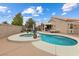 Relaxing in-ground pool and spa, patio area, and string lights create a backyard oasis at 5107 Morning Splash Ave, Las Vegas, NV 89131