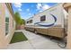 Large RV parked on the side of a home with landscaped yard and clear skies at 5107 Morning Splash Ave, Las Vegas, NV 89131