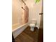 Bathroom featuring combination shower-tub and toilet with wood look flooring at 5245 Golden Ln, Las Vegas, NV 89119