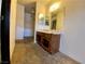 Bathroom featuring a single vanity, open storage space, and a large mirror at 5245 Golden Ln, Las Vegas, NV 89119