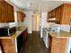 Bright kitchen features wooden cabinets, laminate countertops, and modern microwave at 5245 Golden Ln, Las Vegas, NV 89119