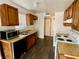 Bright kitchen features wooden cabinets, laminate countertops, and modern microwave at 5245 Golden Ln, Las Vegas, NV 89119