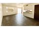 Open-concept living space with sliding glass doors, wood-look floors, and breakfast bar at 5245 Golden Ln, Las Vegas, NV 89119