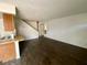 Spacious living room area with wood-look vinyl floors leading to a staircase at 5245 Golden Ln, Las Vegas, NV 89119