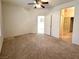 Spacious bedroom featuring a ceiling fan, neutral carpet, and access to the bathroom at 5327 Progresso St, Las Vegas, NV 89135