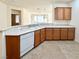 Well-lit kitchen features wood cabinets and a large sink with tile flooring at 5327 Progresso St, Las Vegas, NV 89135