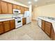 Functional kitchen features wooden cabinets and modern white appliances at 5327 Progresso St, Las Vegas, NV 89135