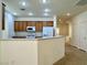 Cozy kitchen featuring wood cabinets, modern appliances, and bar seating area at 5327 Progresso St, Las Vegas, NV 89135