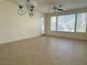 Bright living room with tile flooring, several windows, and a glass door to outside at 5327 Progresso St, Las Vegas, NV 89135
