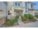 Inviting front entrance with a rustic wood door and beautiful stone accents, landscaped for curb appeal at 5337 Polizze Ave, Las Vegas, NV 89141