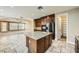 Spacious kitchen featuring a granite island, stainless appliances, and access to a walk-in pantry at 5337 Polizze Ave, Las Vegas, NV 89141