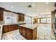 Spacious kitchen with an island, granite countertops, and wooden cabinetry open to living space at 5337 Polizze Ave, Las Vegas, NV 89141
