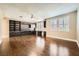 Spacious living room featuring hardwood floors, built-in shelves, and lots of natural light from multiple windows at 5337 Polizze Ave, Las Vegas, NV 89141