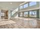 Large living room with travertine floors, big windows, and stylish light fixture at 5337 Polizze Ave, Las Vegas, NV 89141