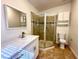 This bathroom has a single sink vanity, tile floors, and glass shower stall at 5384 Hanging Tree Ln, Las Vegas, NV 89118
