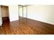 Bedroom featuring hardwood floors, sliding door closet, and neutral walls at 5384 Hanging Tree Ln, Las Vegas, NV 89118