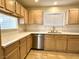 Bright kitchen featuring wood cabinets, stainless steel appliances, and light countertops at 5384 Hanging Tree Ln, Las Vegas, NV 89118