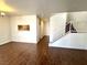 Open floorplan living room with hardwood floors, natural lighting, and a staircase at 5384 Hanging Tree Ln, Las Vegas, NV 89118